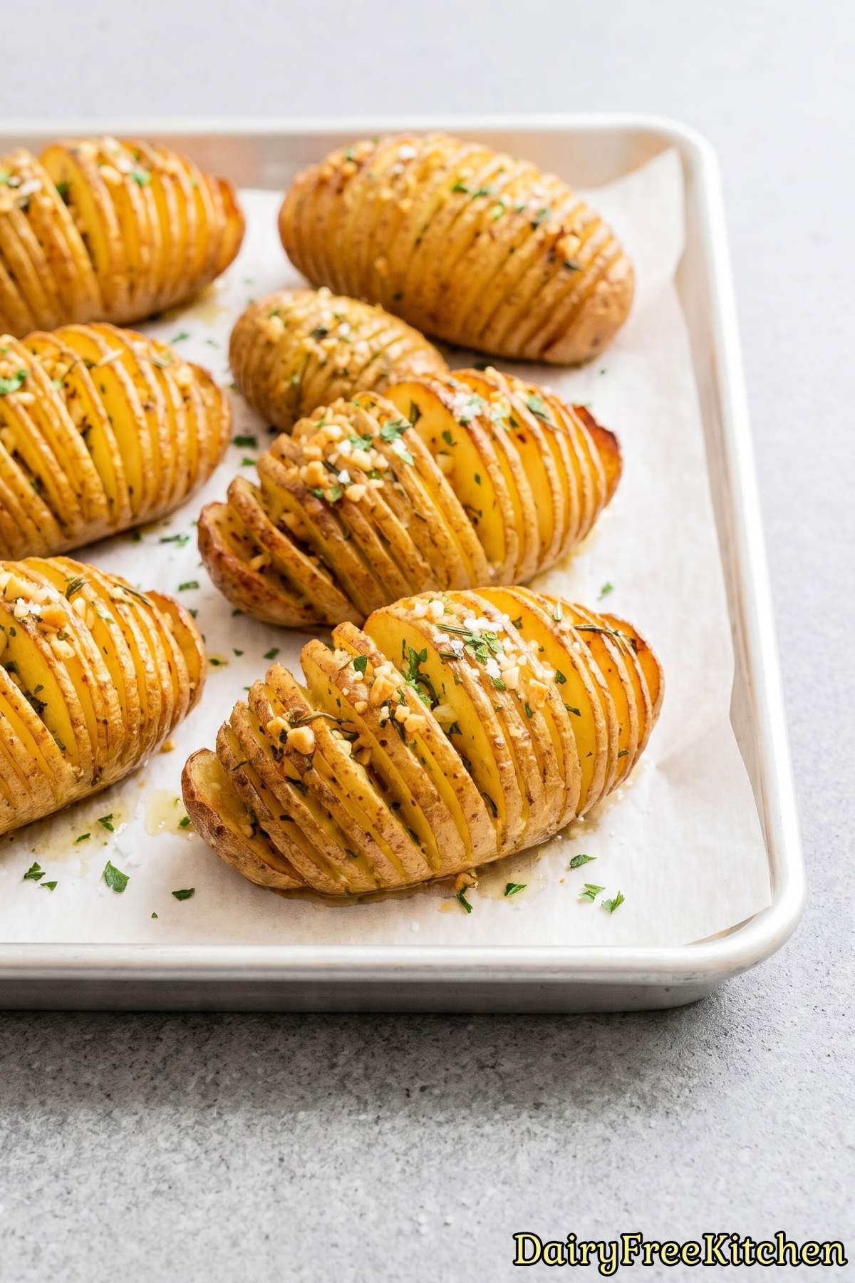 Tender sliced garlic herb potatoes on a plate