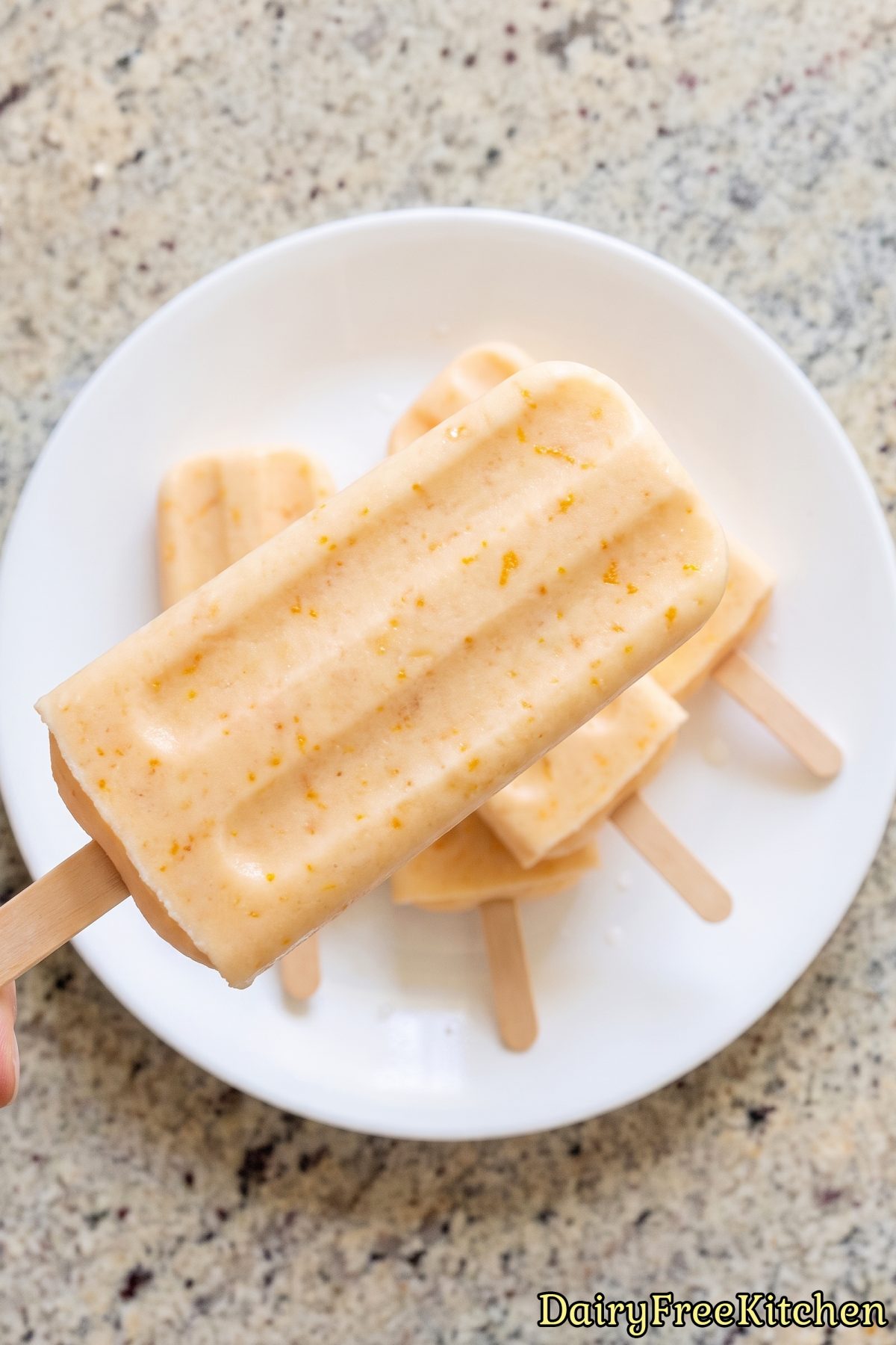 Creamy orange pudding pops on a tray
